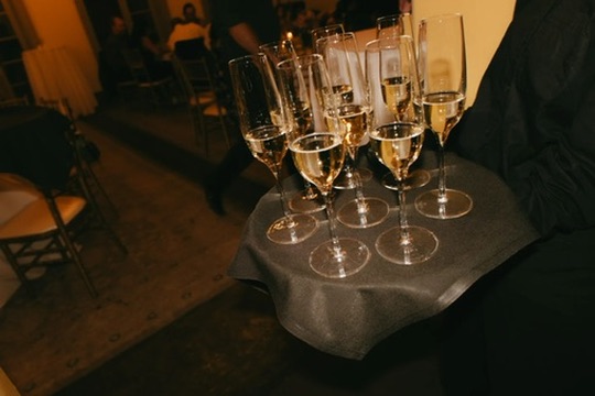 Champagne flutes on a tray during a luxury wedding reception