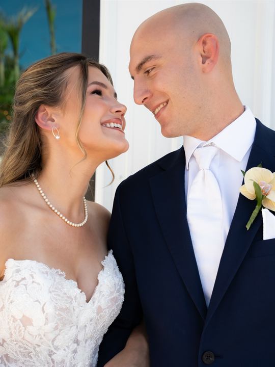 A couple close together in navy and lace