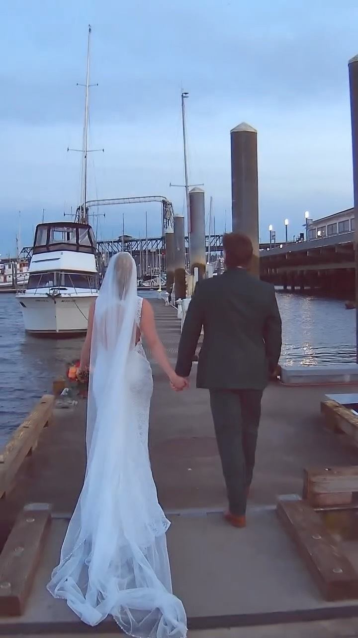 A bride stands gracefully near the waterfront