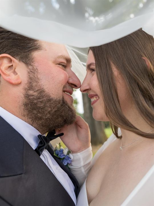 A couple embraces closely on their wedding day